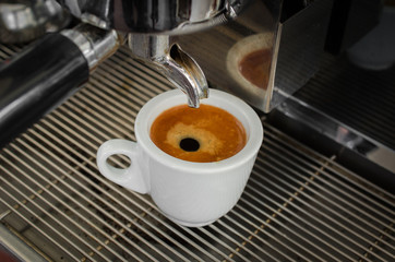 cooked cup of espresso coffee machine is on