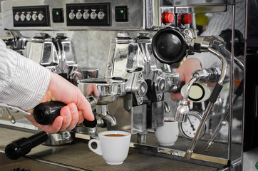 cooked cup of espresso coffee machine is on