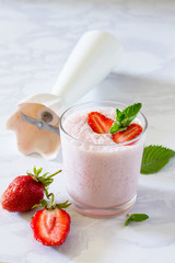 Fresh summer drink cocktails with strawberries on a background of gray stone. The concept of a healthy diet and diet. Copy space.