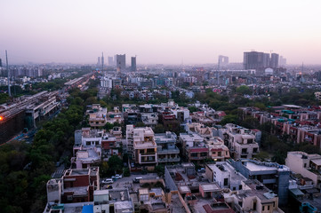 Obraz premium Noida cityscape at night with lights on the buildings and the construction cranes clearly visible