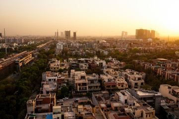 Noida cityscape at dusk with the under construction buildings and golden sunset light