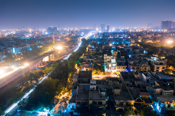 Cityscape of Noida Delhi at night with lights and under construction buildings