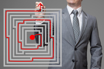Businessman finding the solution of a maze