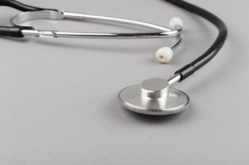 Stethoscope - medical instrument on the grey background