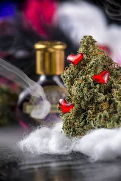 Cannabis bud (love potion marijuana strain) with smoke dark background