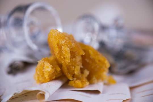 Detail of marijuana extraction concentrate aka wax crumble on wood background