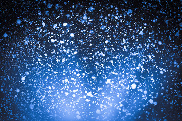 Naklejka na ściany i meble Abstract bokeh or glitter lights on blue background. Circles and defocused particles. Design template