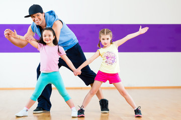 Fototapeta na wymiar Dance teacher giving kids Zumba dancing class