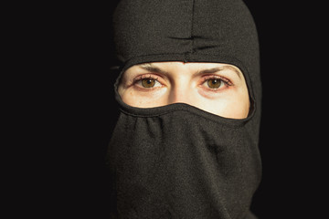 Girl offender. The girl in a black mask.