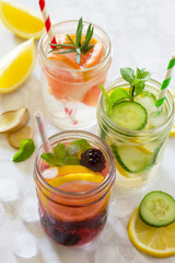 Fototapeta na wymiar Fruit refreshing water. Summer cold drinks with blackberries, grapefruit, lemon and mint. The concept of healthy and dietary nutrition.