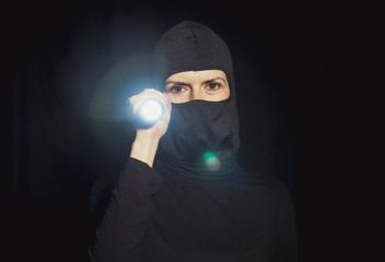 Girl offender. The girl in a black mask.