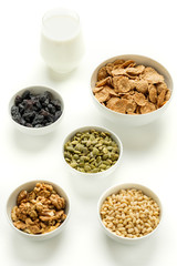 Healthy food. Milk, multi grain flakes and nuts for breakfast.