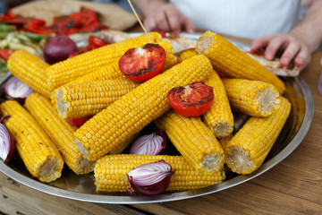 Fresh corncobs cooked at barbecue grill