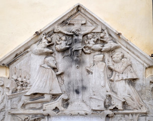 Crucifix, bas relief on the facade of Cathedral of Saint John The Baptist, Maribor, Slovenia.