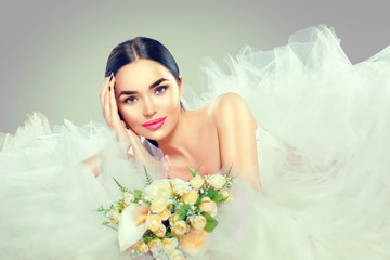 Beauty model bride in wedding dress with long train. Beautiful fiancee in elegant white wedding dress