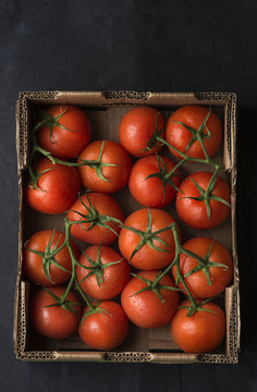 Whole tomatoes in cardboard box 