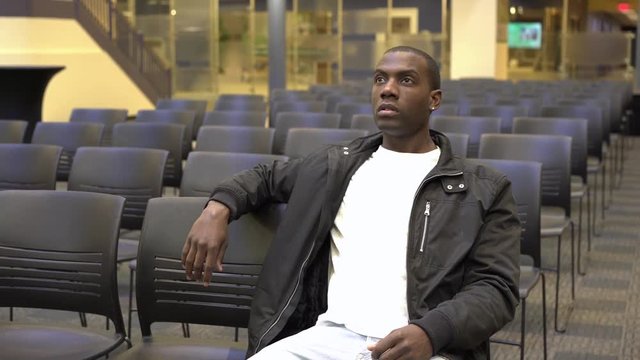 Young impressionable mind at university sitting in auditorium watching a speaker.