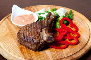 grilled meat on the bone with sauce