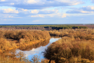 Typical landscape of Central Russia in the spring. The river among the trees on the plain.