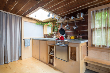 Rustic kitchen in a bright cabin. Interior design.