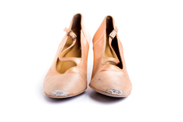 closeup shot of pair of worn-out latin ballroom dance shoe - isolated