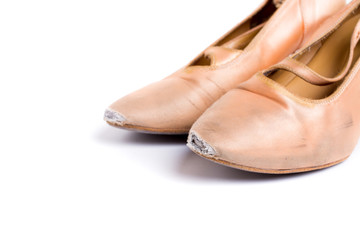 closeup shot of pair of worn-out latin ballroom dance shoe - isolated