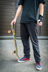 Skateboarders below belt whith skateboard