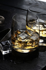 whiskey with ice on a wooden table