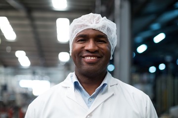 Factory engineer standing in bottle factory
