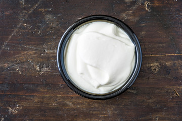 Bowl of White Yogurt on Wooden Background, Top View