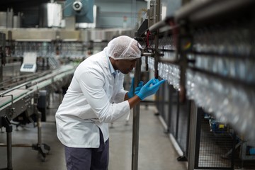 Factory engineer counting bottles 