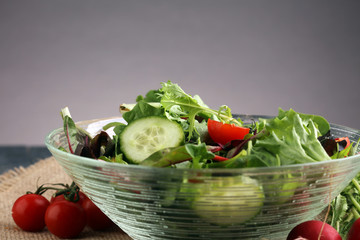 Bowl of salad on wooden table