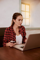 Lovely young woman looking at laptop