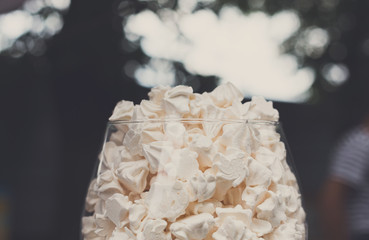 Meringue cookies in glass jar on bar for sale