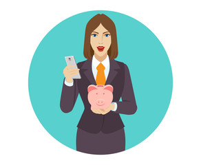 Businesswoman using a mobile phone and holding a piggy bank