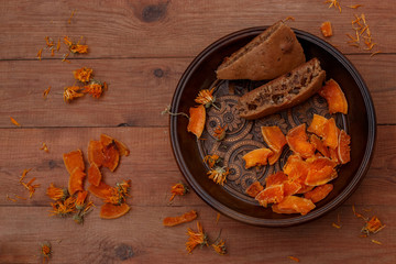 Pumpkin candies and semolina pie on a wooden table