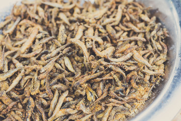 Small anchovy fish grilled at barbecue