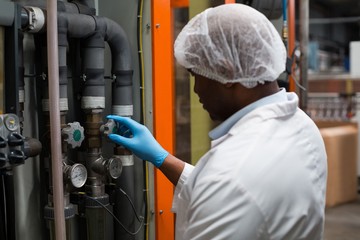 Factory engineer monitoring a pressure gauge in factory