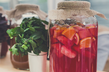 Closeup of lemonades in glass jars at restaurant background