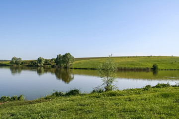 Fototapeta premium Reservoirs and field shelterbelts in the fields near the village of Novoselivka in the Novo-vodolaz'ke district, Kharkiv region of Ukraine. 2007