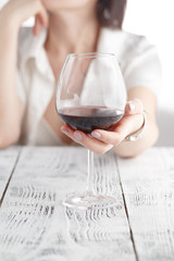 woman drinking alcohol on white background. Focus on wine glass