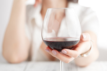 woman drinking alcohol on white background. Focus on wine glass