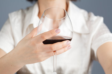 woman drinking alcohol on white background. Focus on wine glass