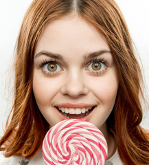 happy woman, naughty look, round lollipop