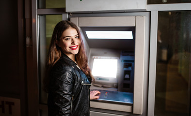 Fototapeta na wymiar Woman at ATM