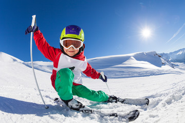 Little skier having fun at sunny snowy day - obrazy, fototapety, plakaty