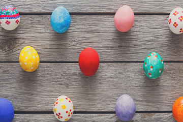 Colorful easter eggs on wood background