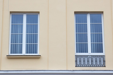 Fototapeta premium Two vintage design windows on the facade of the old house