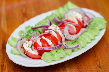 Fresh salad with mozzarella cheese, tomatoes, cucumber