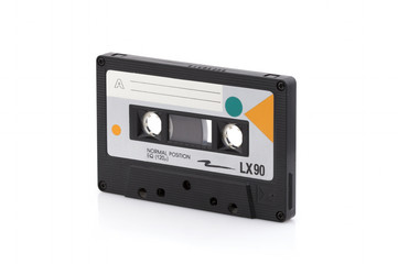 Vintage black compact cassette on white background